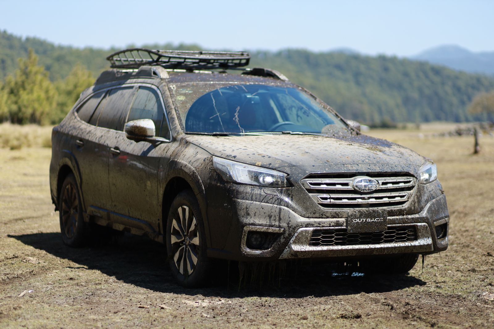 SUV covered in road mud and grime before decontamination